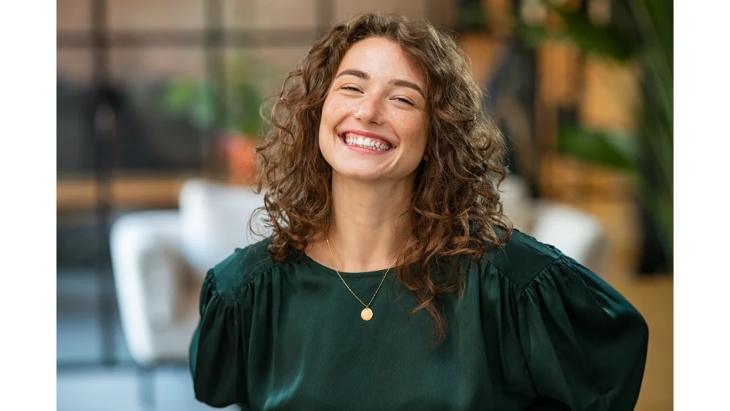 A woman smiling warmly in a published clinic photo